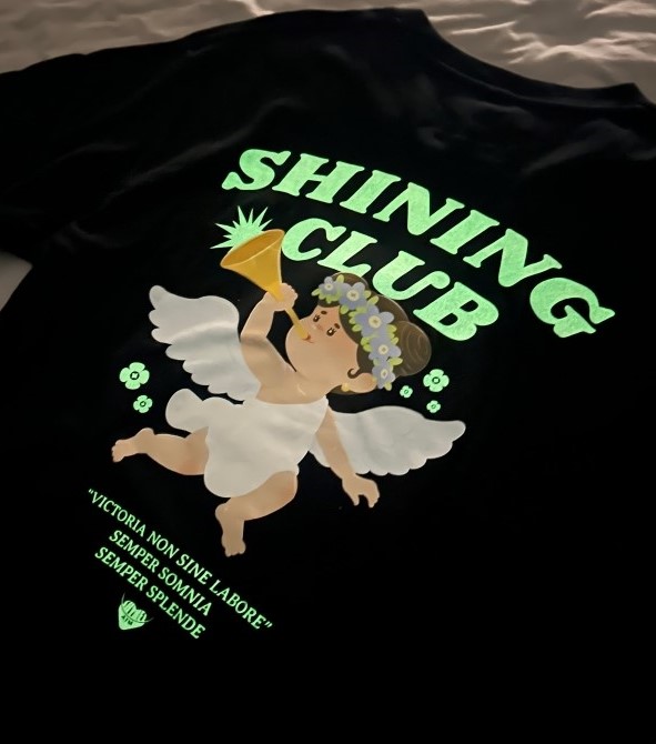 Black glow-in-the-dark printed t-shirt with 'Shining Club' graphic